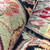 Rolled edge close up showing soft wool pile depth in green, black and salmon tones