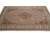 Brown and ivory medallion rug photographed from one corner, floral border rosettes clearly visible