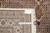 Back tag and tape measure confirming the 6'8" x 10' size of this hand-knotted rug
