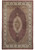 Full overhead view of ruby red Mahi fish design rug with ivory oval medallion and floral border