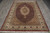 Hand-knotted 6'7" x 9'10" Oriental rug photographed lengthwise with ivory border, red outer edge and cotton fringe