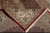 Folded corner showing border rosettes, red selvedge, hand-tied ivory fringe and even back weave