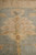 Soft gold palmette rising from the green field toward the ivory inner border, pile detail