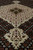 Angled view of pendant and medallion showing knot definition and short even wool pile