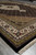 Low angle view across black field toward multi-stripe ivory and gold borders and fringe