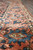 Shrimp main border with blue palmettes and ivory guard stripes on this Persian village rug