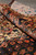 Rolled edge showing thick wool pile depth and shrimp border of this collectible Persian rug