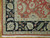 Corner detail with black main border, salmon rosettes, ivory meander guard stripe and cotton fringe