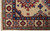 Corner detail of 2'7 x 25'9 Kazak runner with ivory fringe and blue guard border