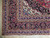 Corner detail with lavender guard stripes, rosette border and clean ivory fringe on wool pile