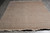 Sage green square area rug laid flat on grey tile showing all over floral field