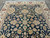 Detail of all over floral design with ivory and gold blossoms on dark blue ground