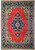 Full view of coral red Persian Sarouk rug with navy medallion, cream spandrels and navy floral border