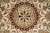 Macro detail of the 8 petal rosette inside the burgundy outlined ivory medallion core