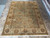 9'1 x 12'4 hand-knotted wool rug displayed flat on stone floor in Freeport showroom