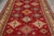 7' x 9'9" Super Kazak rug seen from above, red field with gold and ivory medallions