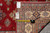 Back of rug with tape measure and tag confirming 7' x 9'9" hand-woven Oriental rug