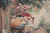 Close view of three costumed figures in crimson coat, blue gown and apricot skirt