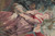 Woven detail of the kneeling woman in rose pink dress holding a shepherd's staff