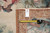 Reverse edge with original dealer tag, tape measure and warp ends showing flat tapestry construction