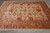 7'9" x 9'9" Afghan Ziegler rug angled view showing olive main border and ivory guard stripes