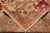 Folded corner showing hand-knotted wool pile depth, cotton foundation back and coral border detail