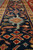 Low angle close-up of the navy main border with gold guard stripe and geometric palmettes