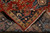 Folded corner showing wool pile, cotton foundation back and hand-tied ivory fringe of the rug