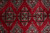 Close-up of square Jaldar guls with sage green crosses, peach triangles and black outlines