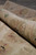 Rolled rug showing soft fine weave wool pile, flexible handle and faded border colors