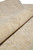 Rolled edge photograph highlighting soft natural wool pile depth and hand spun yarn luster