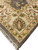 Fringed corner detail with large ivory border palmette in brown, rust and sage tones
