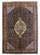 Full view of 6'8" x 9'9" Persian Ardebil rug with navy mahi field and rust border