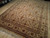 Angled showroom view of 8x10 traditional wool rug, gold field and scrolling vine border