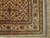 Corner detail showing ivory main border, blossom vine scroll and hand-tied ivory fringe