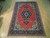 7' x 10'8" Sarouk rug displayed on light hardwood floor showing full medallion and border layout