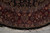 Curved burgundy border and ivory fringe of 8' x 8' round Indian rug on tile