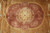 Close-up of the rose medallion with ivory rosette, scrolling lotus palmettes and golden cartouche frame