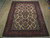 7'2" x 10'5" Persian Sarough rug shown flat on light wood floor, ivory floral field