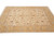 Angled front view showing ivory field, golden main border and sage palmettes on hand-knotted wool