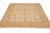 Beige and gold Zigler area rug photographed from the corner, wide floral border framing the field