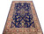 7x10 Sarouk design Oriental rug angled floor view, navy ground, rust border, green flowers