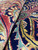 Close-up of lustrous wool pile showing dense knots, rose border and navy floral detail