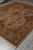 8' x 10' Indian Jaipur rug shown lengthwise displaying symmetrical medallion and floral panel field