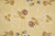 Berry red rosettes and blue bellflowers on soft gold ground, handwoven wool flat weave detail