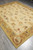 8 x 10 flat weave Aubusson rug viewed lengthwise on grey tile, allover floral field