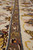 Taupe minor border detail with ivory bird figures, gold scrollwork and blue guard stripe