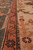 Border detail of 8'10" x 10'7" wool rug, rust guard stripe beside green palmette band
