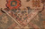Folded corner showing reverse side, salmon border drawing and even hand-knotted wool pile density