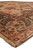 Angled corner view of new Indian wool rug showing fringe, salmon guard border and green band